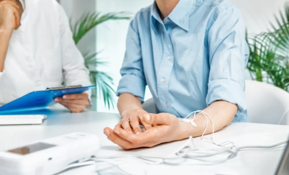 provider using a biofeedback machine on their patient's arm