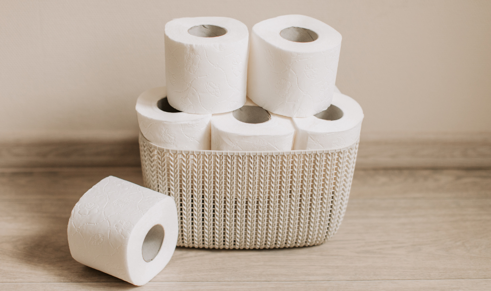 a basket of toilet paper stacked full