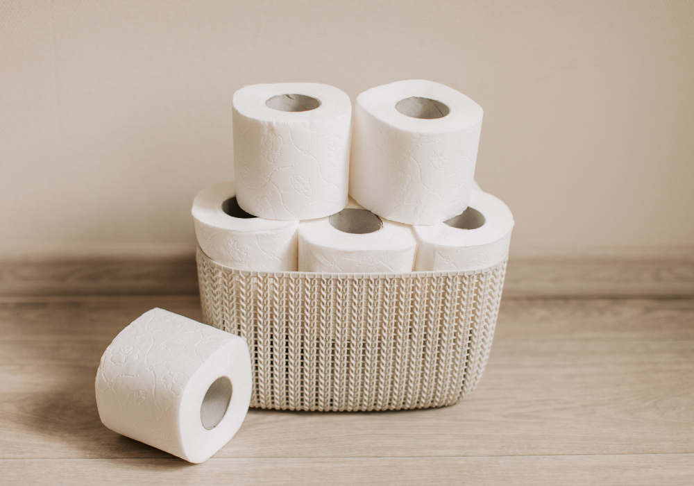 a basket of toilet paper stacked full