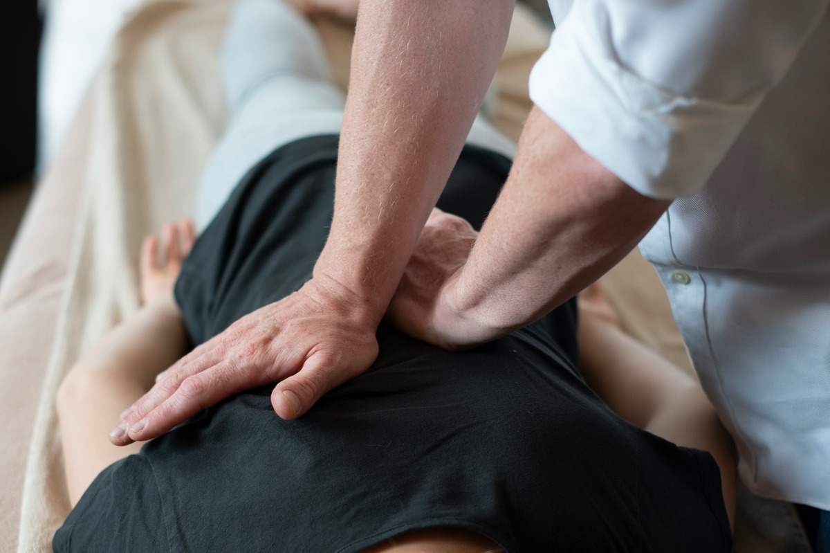 provider performing spinal manipulation on a patient