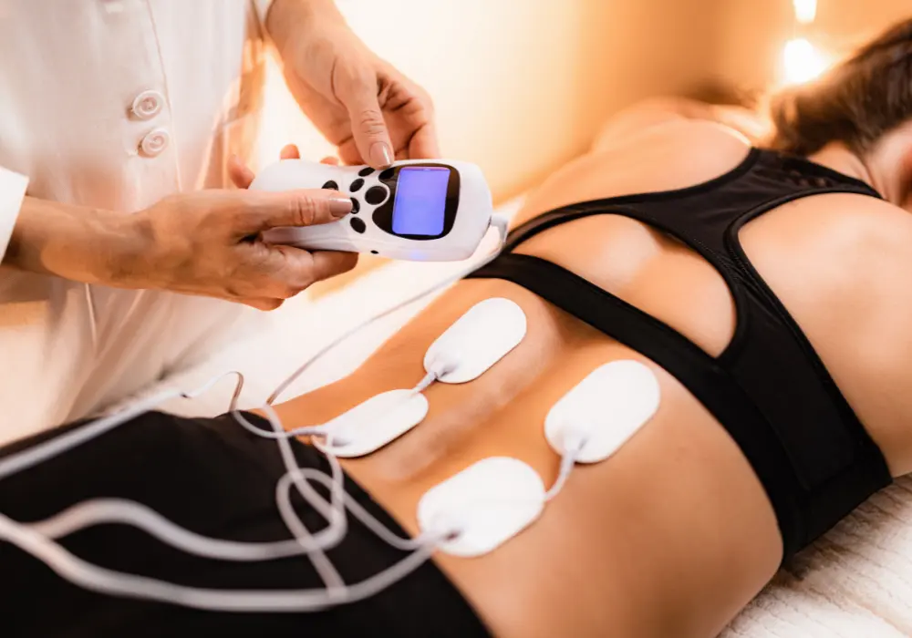 Woman receiving electrical muscle stimulation on her back