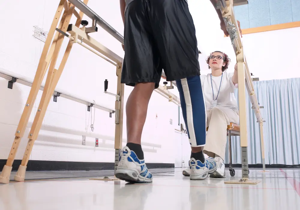 provider supervising a patient as they practice gait training