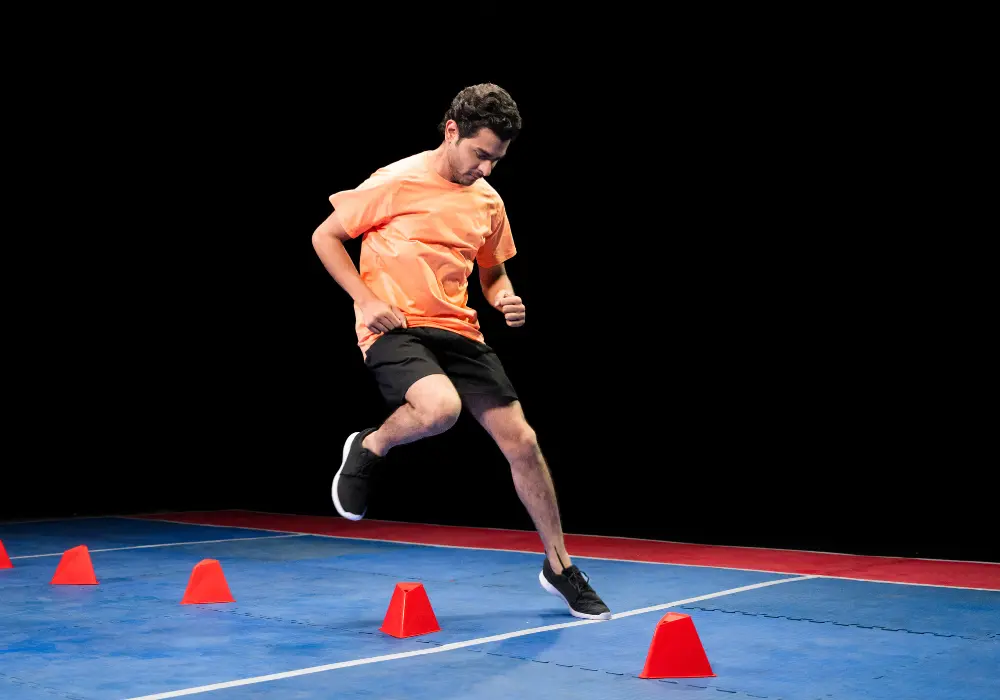 man participating in sports performance training using cones