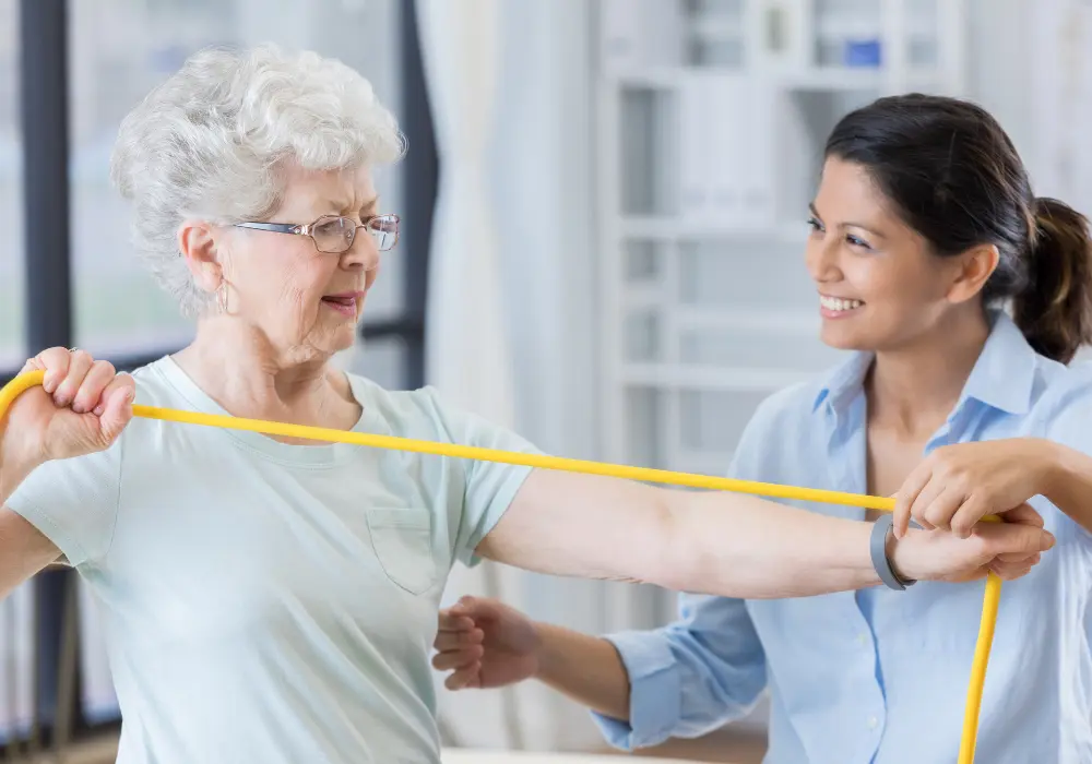 physical therapist helping a patient perform therapeutic activity