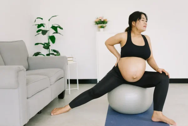 Pregnant person exercising on a balance ball