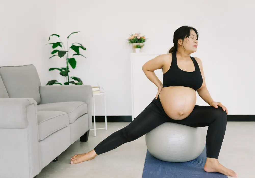 Pregnant person exercising on a balance ball