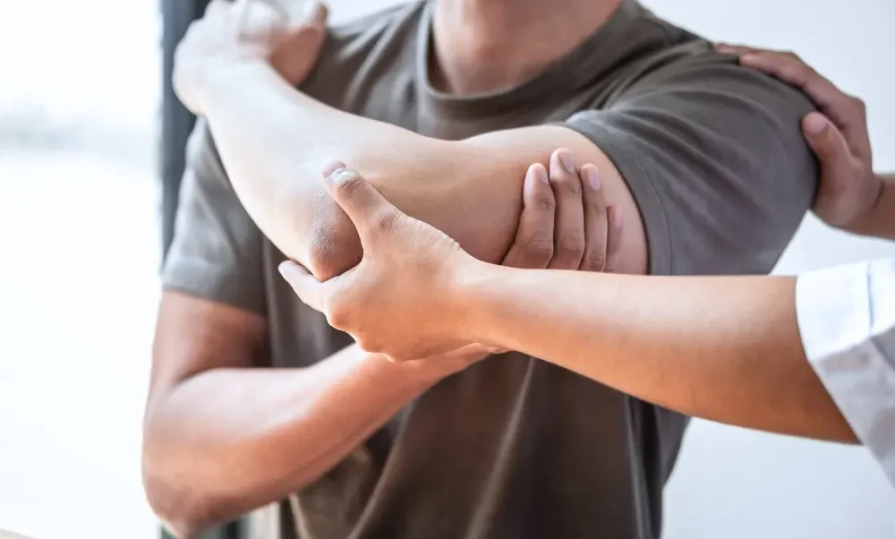 provider evaluating a patient's elbow