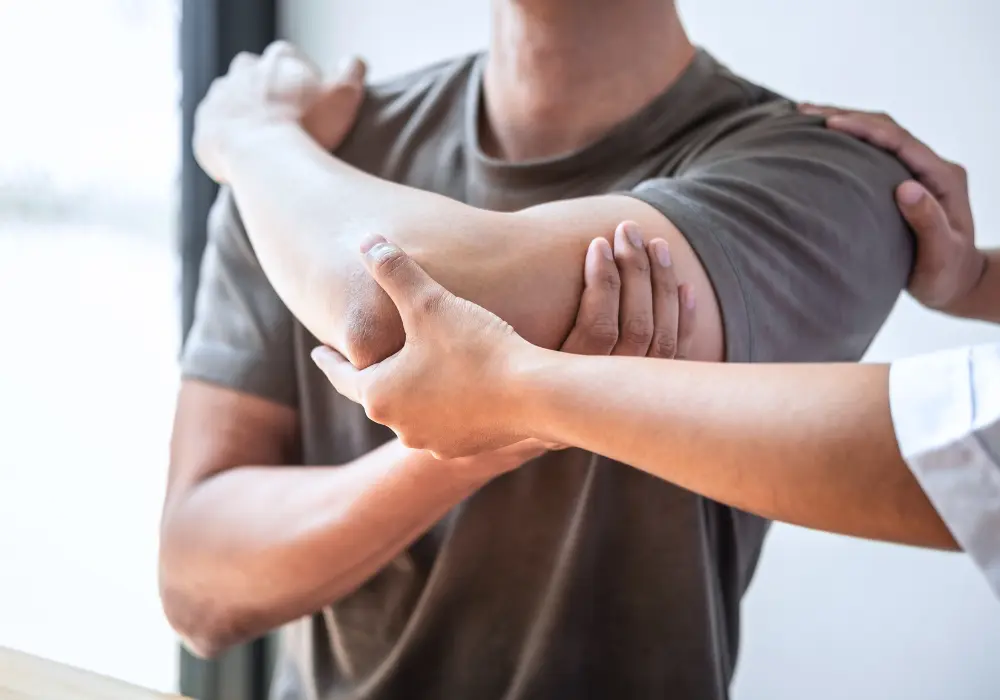 provider evaluating a patient's elbow