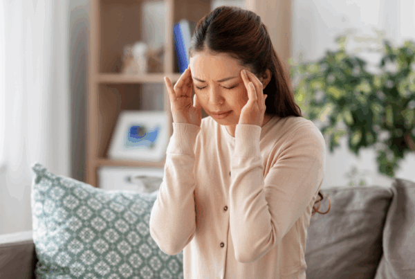 woman with a headache holding her temples