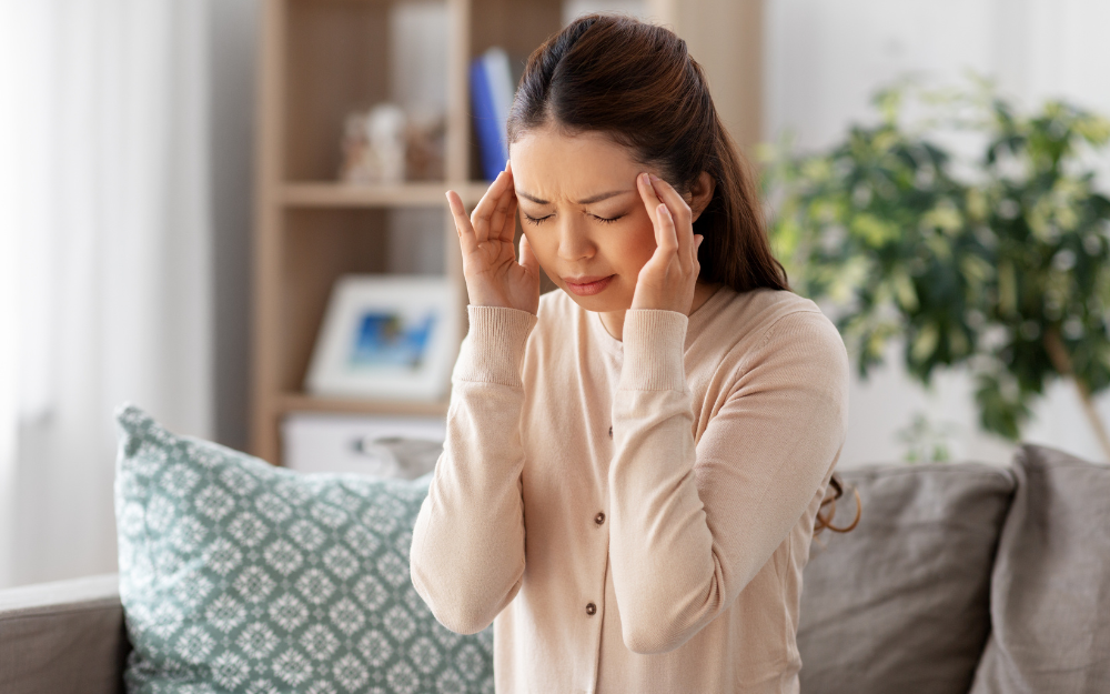 woman with a headache holding her temples