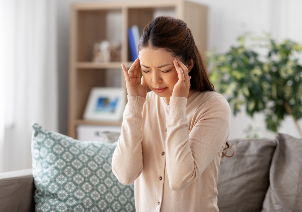 woman with a headache holding her temples