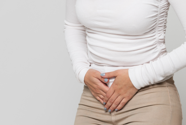 Person with IBD holding their stomach