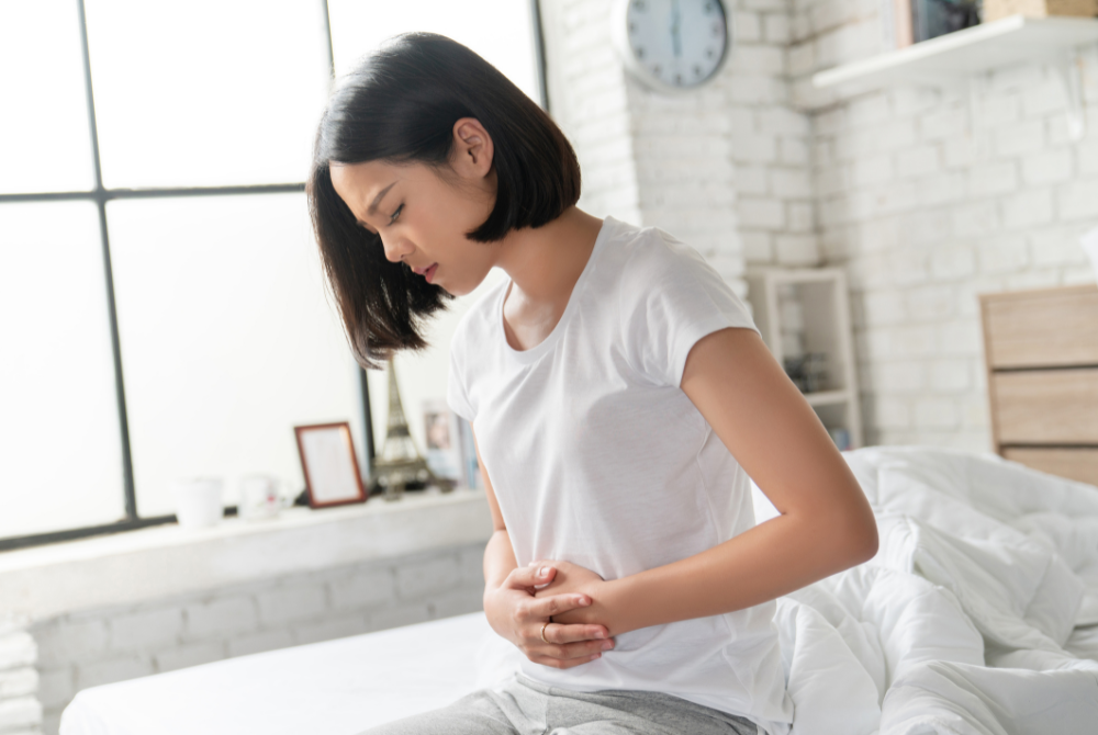 Woman with celiac disease holding her stomach