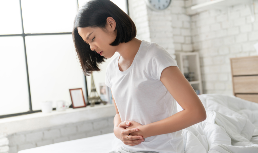 Woman with celiac disease holding her stomach