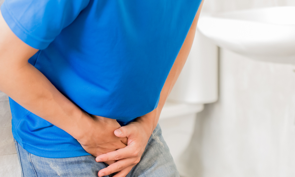 Person holding their pelvic area due to dysuria