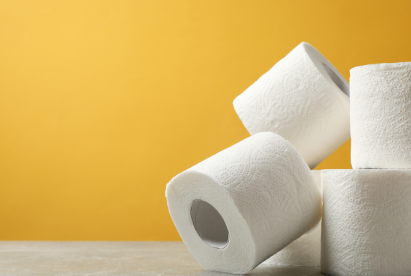 Rolls of toilet paper against a yellow background