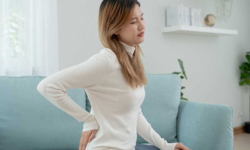 Person with myofasical pain syndrome causing pain in their back