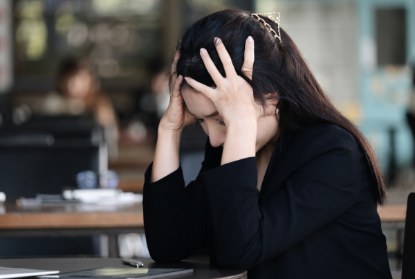 Person with chronic pain holding their head in frustration