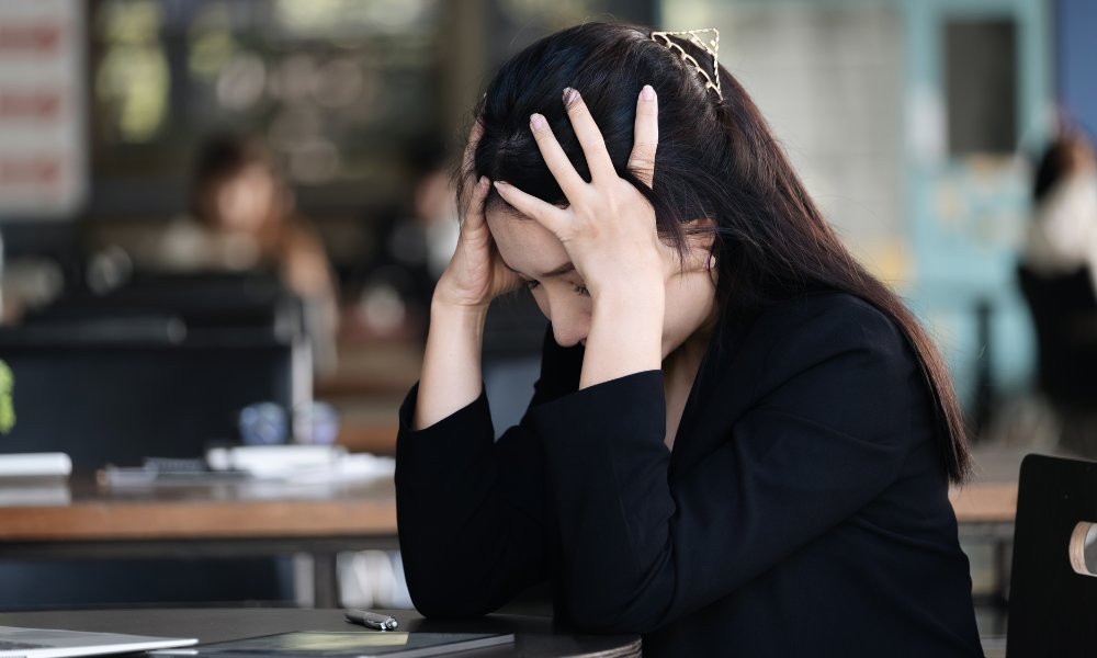 Person with chronic pain holding their head in frustration