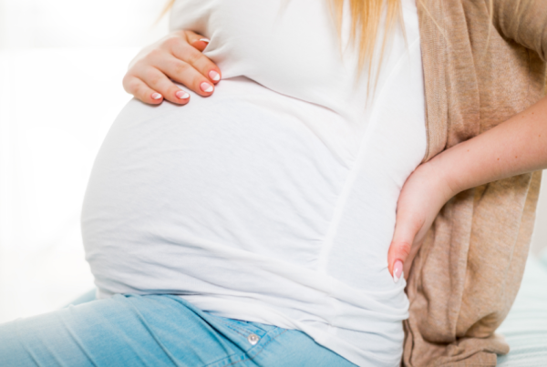 Person with lower abck pain due to pregnancy