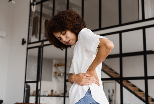 Person holding their side from pelvic pain