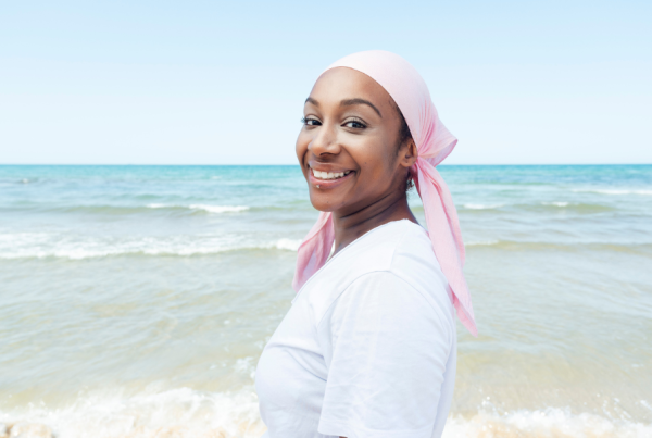 Woman wearing a pink bandana to represent cancer awareness