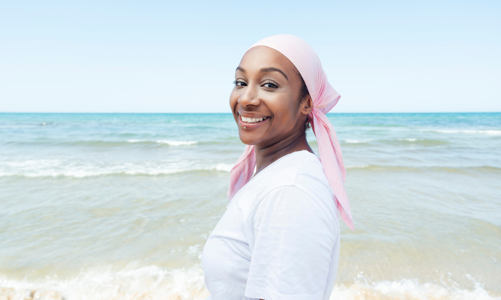 Woman wearing a pink bandana to represent cancer awareness
