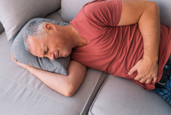 man lying down with pelvic and abdominal pain