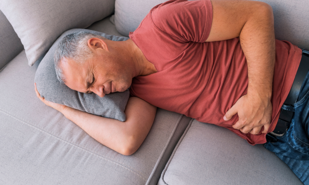 man lying down with pelvic and abdominal pain