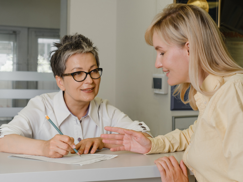 patient having a conversation with a medical provider who is taking notes
