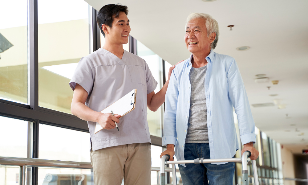 Physical therapist walking with a patient who is using a walker